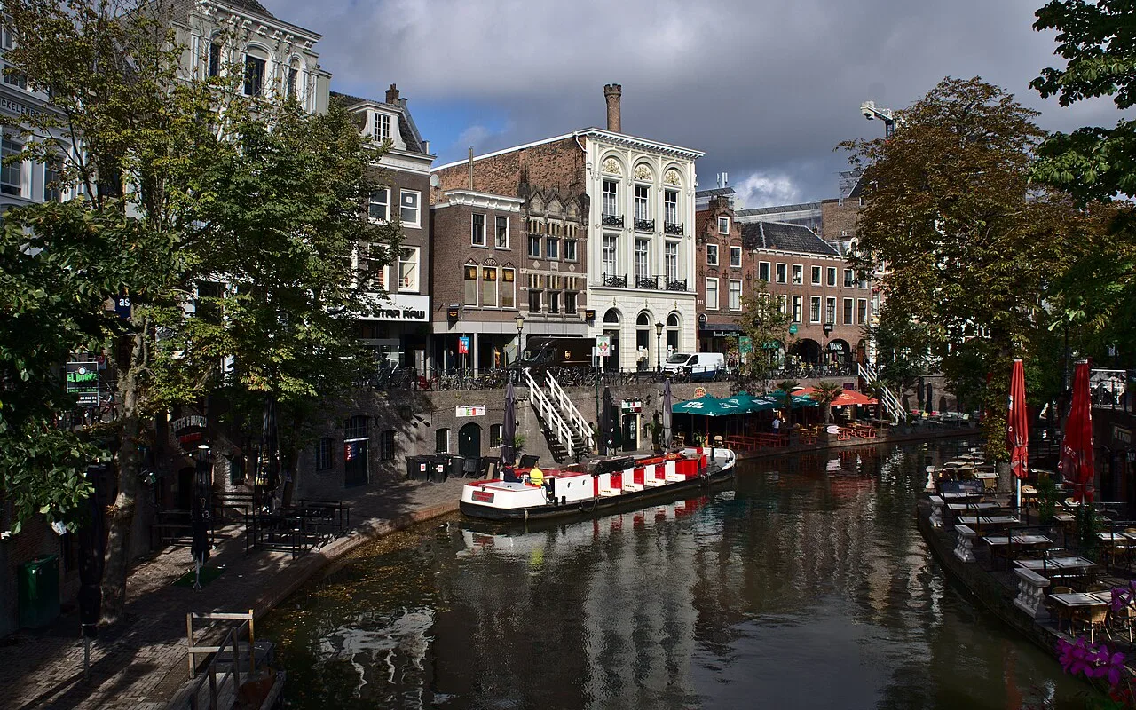 Utrecht's Oudegracht canal with its wharf-level terraces and a canal boat