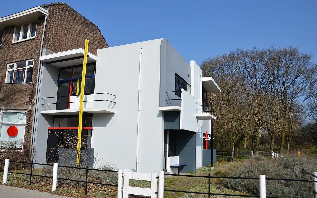 The Rietveld Schröder House seen from the corner, with its yellow post, red and blue bars and white and grey planes